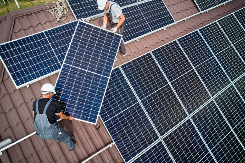 Men from Moy Solar installing panels on roof of house