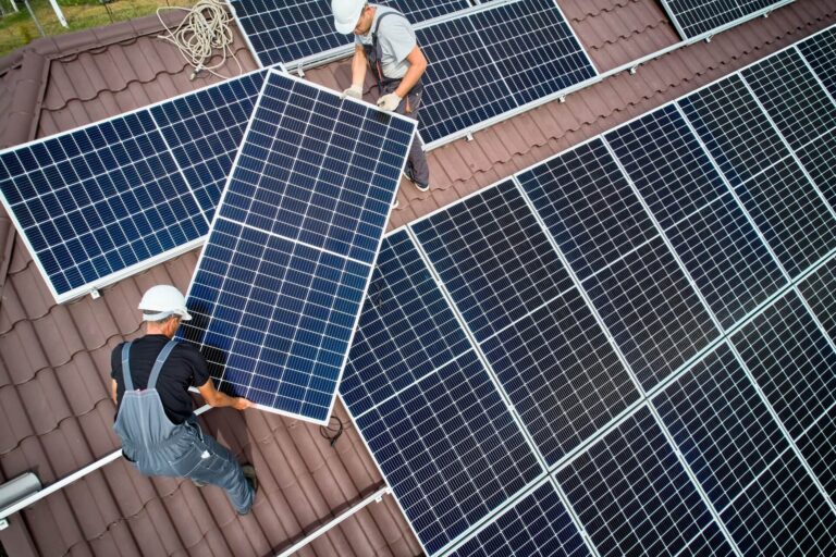 Men from Moy Solar installing panels on roof of house